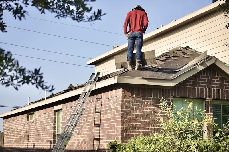 Professional roofer working on a residential roof in Swedesford Road